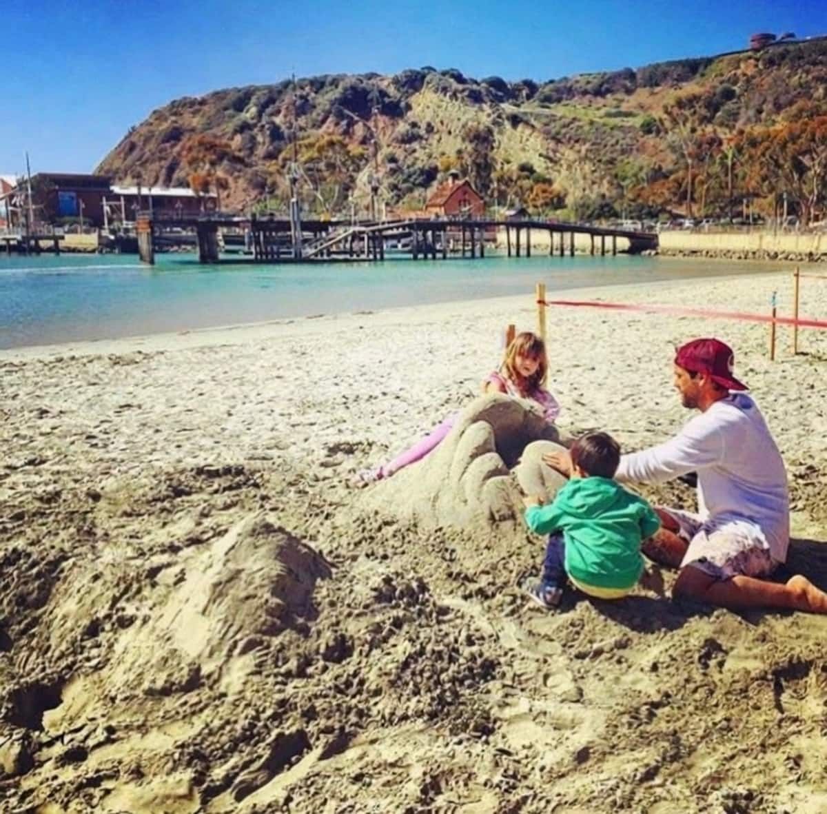 Family sculpting sand near Dana Point harbor